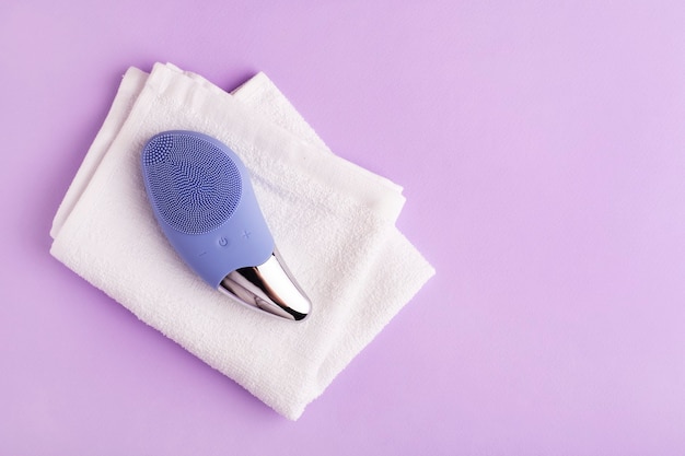 purple cleansing brush for the face on purple