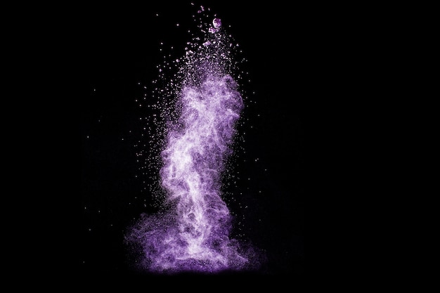 Photo purple color powder explosion on black background.