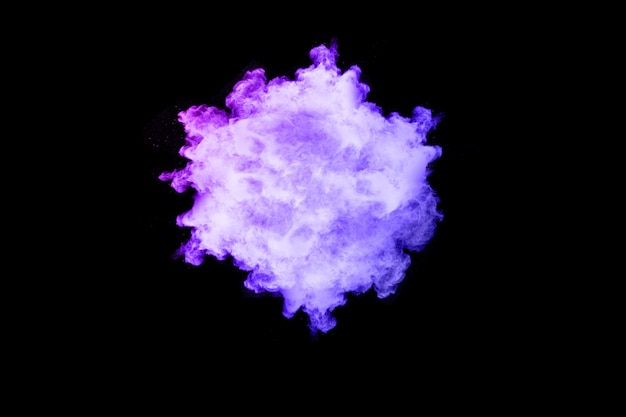 Photo purple color powder explosion on black background.