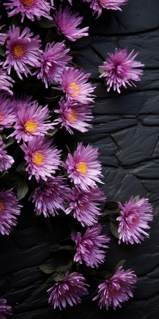 Photo purple colored flowers on black brick tiled wall low depth of field