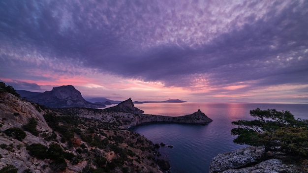 Purple dawn over the mountains on the sea coast