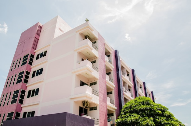 Purple dormitory building with blue sky background.