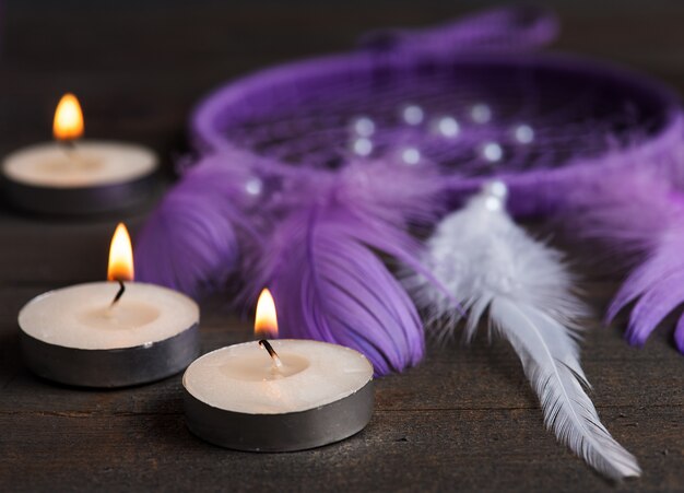 Purple dream catcher and candles, close-up