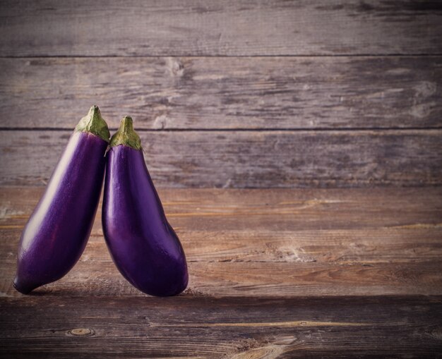 Premium Photo  Scarlet eggplant on a wooden board and wooden background