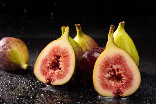 purple figs, open purple figs being sprayed with water
