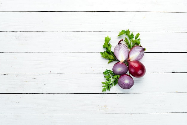 Purple fresh onion on white wooden background Top view Free copy space