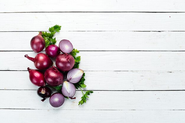 Purple fresh onion on white wooden background Top view Free copy space