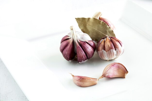 Purple garlic on white plate