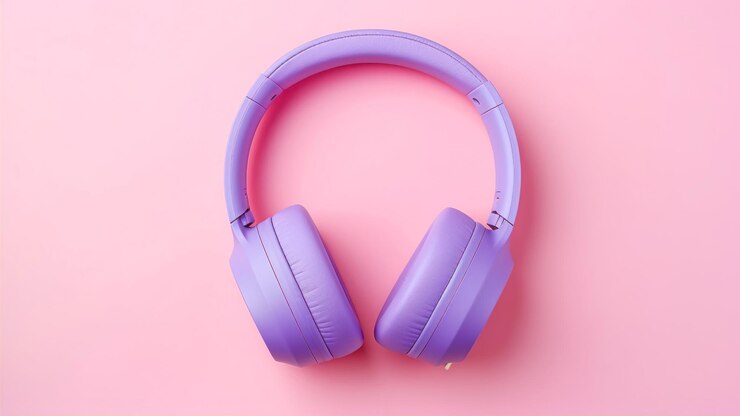 Purple headphones on a pink background Flat lay top view
