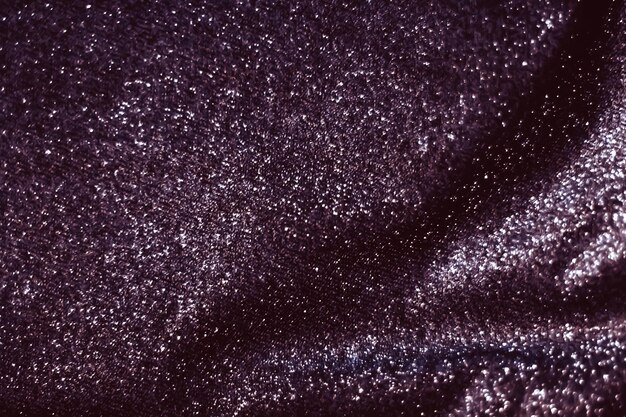 Фото Фиолетовый праздник сверкающий блеск абстрактный фон роскошный блестящий тканевый материал для гламурного дизайна и праздничного приглашения