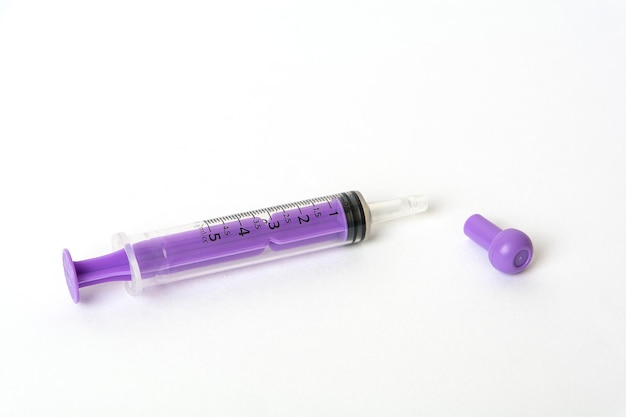 purple Injection for kids syrup medicine on white background