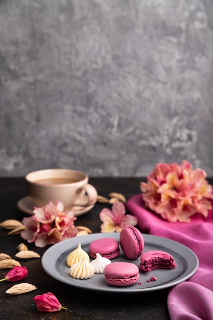 Purple macarons or macaroons cakes with cup of coffee