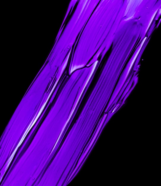 Purple neon paint brush stroke texture isolated on black background