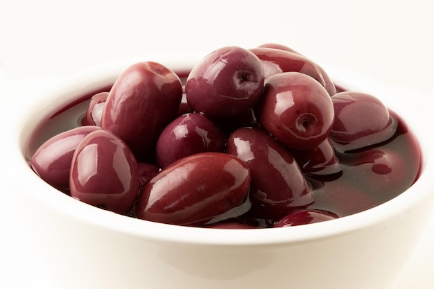 Purple olives in white bowl