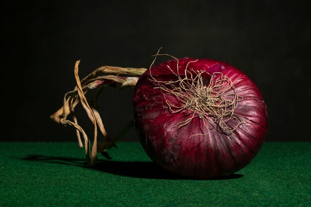 Purple onion close up on green background