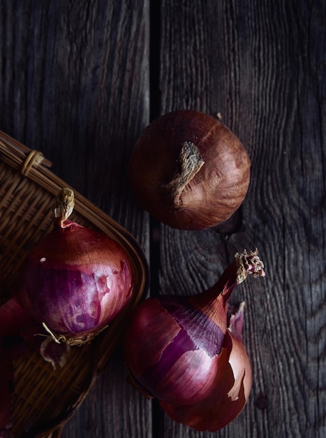 Purple onions on a wooden table