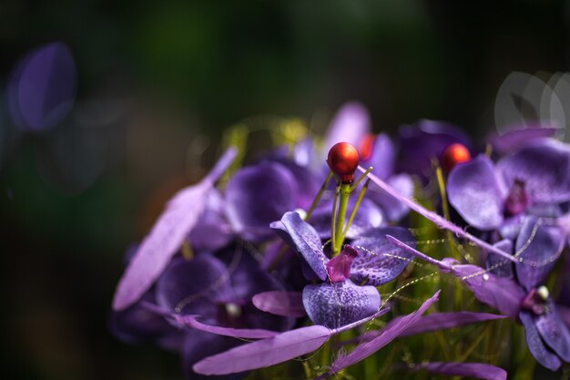 Photo purple petals with gold wire closeup on blurred background