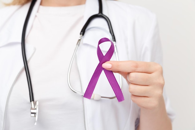 Purple ribbon in the doctor's hand isolated