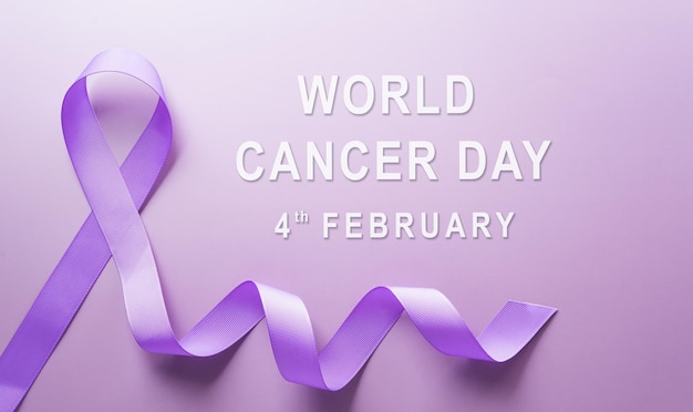 Photo purple ribbon on pastel paper background for supporting world cancer day campaign on february 4