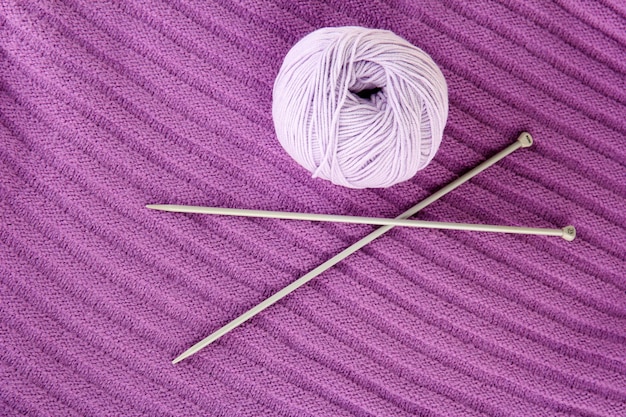 Purple sweater and a ball of wool closeup