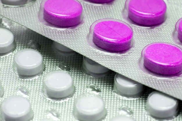 Purple tablets in a close-up blister. Medications