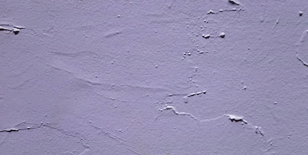 A purple wall with a small black dot on it