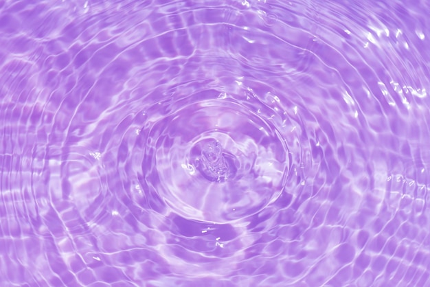 Purple water with ripples on the surface Defocus blurred transparent pink colored clear calm water