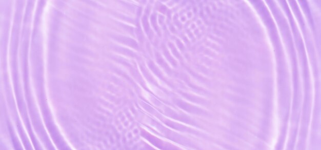 Purple water with ripples on the surface defocus blurred transparent pink colored clear calm water