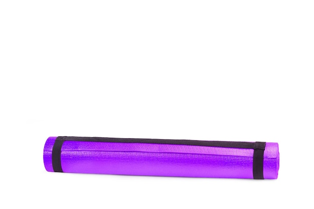 A purple yoga mat on a white background with copy space