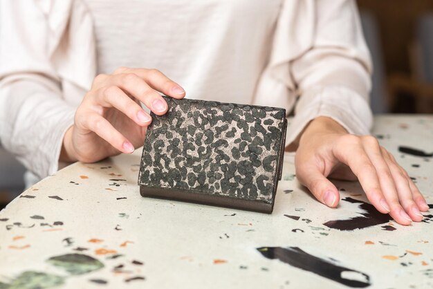 Photo purse in the hands of a girl in white