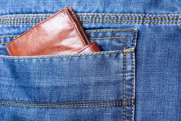 Purse or wallet in the back pocket of blue jeansClose up