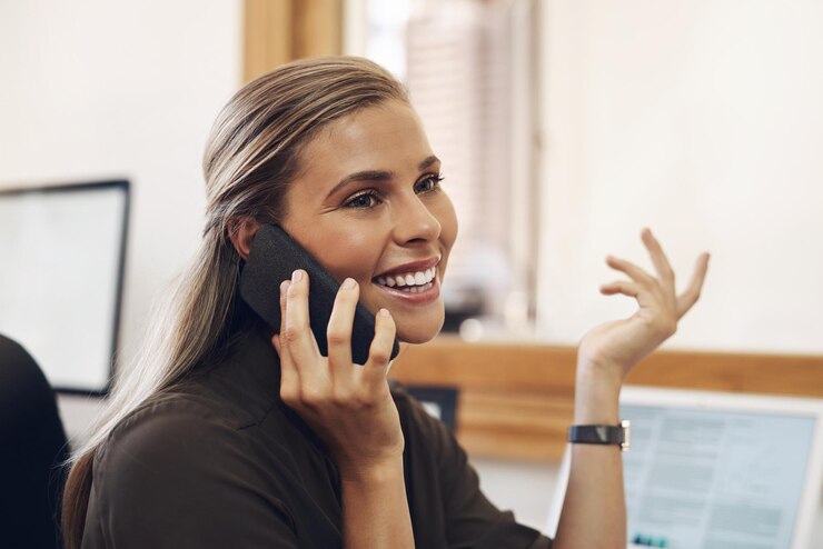 Photo pursuing big things in business shot of a young businesswoman talking on a cellphone in an office