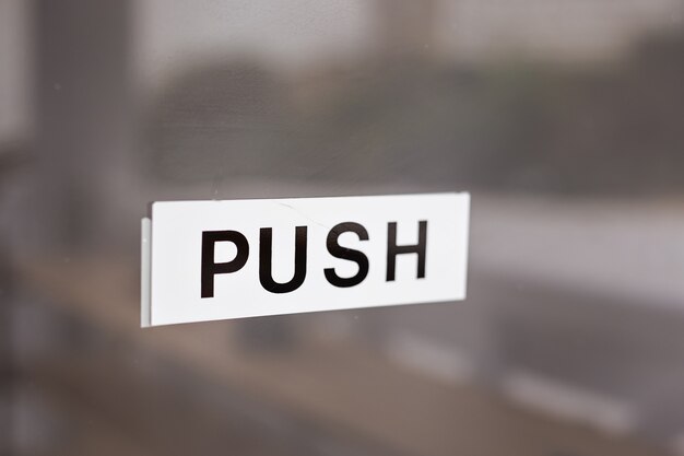 PUSH sign on glass door. Push inscription