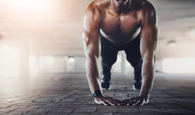 Push up fitness and man in city parking lot for intense training exercise and cardio workout Sports athlete and person with muscle strength and performance for wellness health and endurance