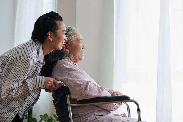 Pushing Wheelchair of Sick Mother