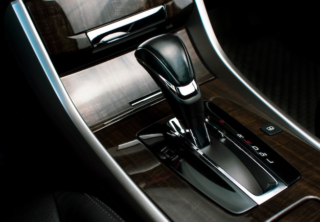 Put a gear stick into P position (Parking) and gear position symbol on automatic transmission in a luxury car.