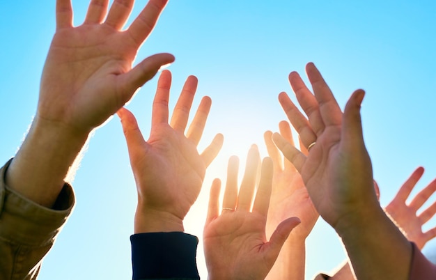 Put your hands in the air and celebrate life Cropped shot of a group of unrecognizable peoples hands outside