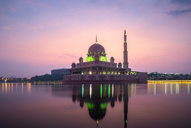 Putrajaya mosque or pink mosque with lake between sunrise in Kuala Lumpur