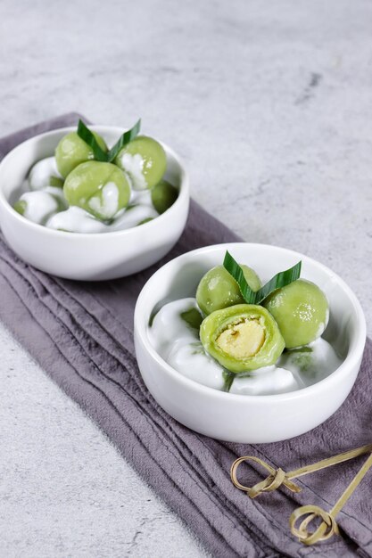 Putri mandi or badak berendam Steamed glutinous rice with potato balls filled with green bean paste