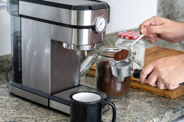 Premium Photo  Making coffee at home with an espresso machine frozen  coffee movement.