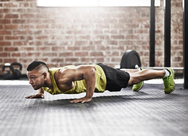 Putting everything into his training session Full length shot of a young man working out in the gym