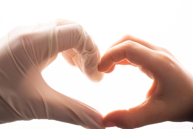 Photo putting on latex gloves on hands for protection make heart shape