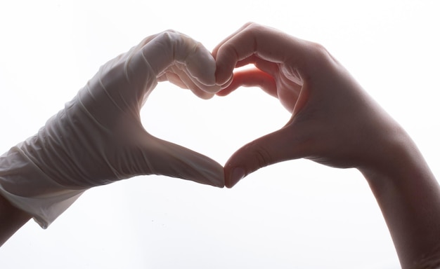 Photo putting on latex gloves on hands for protection make heart shape