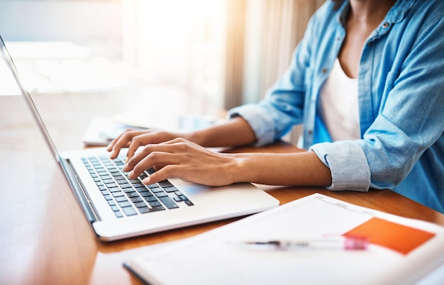 Putting in some hard work over the weekend Shot of an unrecognizable young woman working on her laptop at home