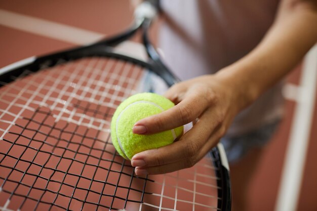 Putting tennis ball on racket