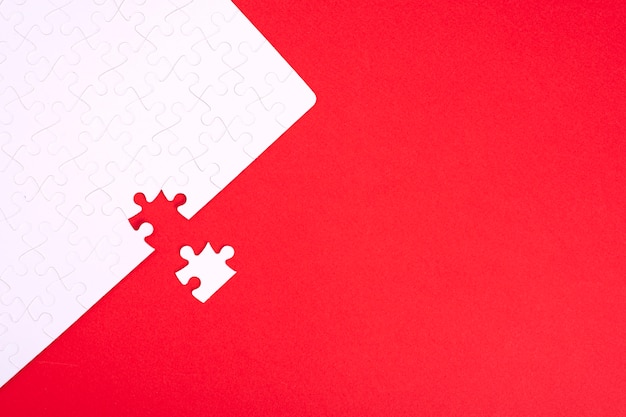 puzzle of white pieces on red background with place for your text