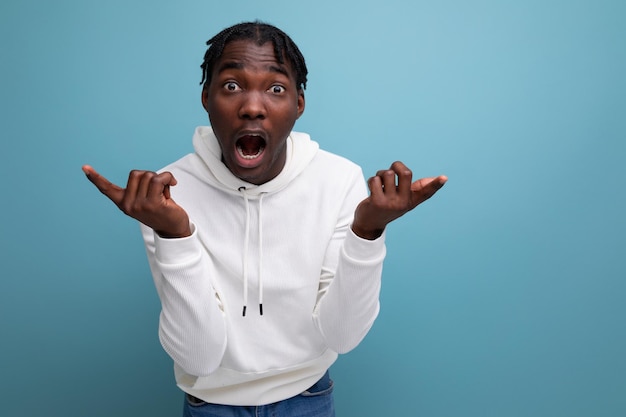 Puzzled darkskinned young brunette male in studio isolated background