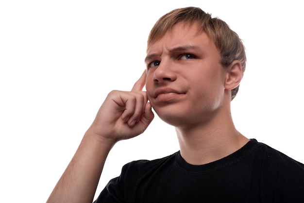 Puzzled teenager boy holding his head