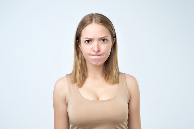 Puzzled woman  biting her lips and having some doubts