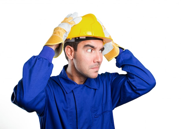 Puzzled worker on white background